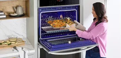 lg-smart-double-wall-oven-convection-and-air-fry-woman-cooking